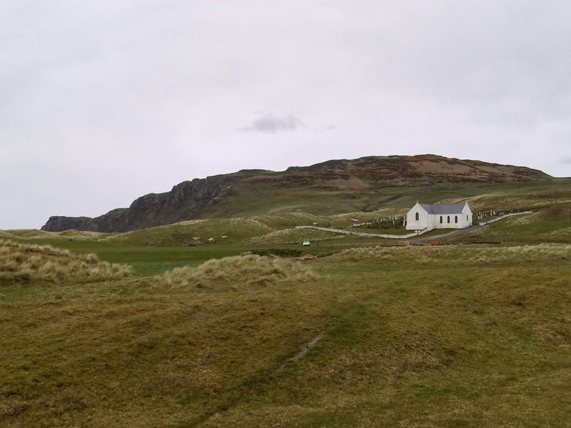 Pretty as a picture... The beautiful church nestled among the hills and visible from the road between Malin and Malin Head.