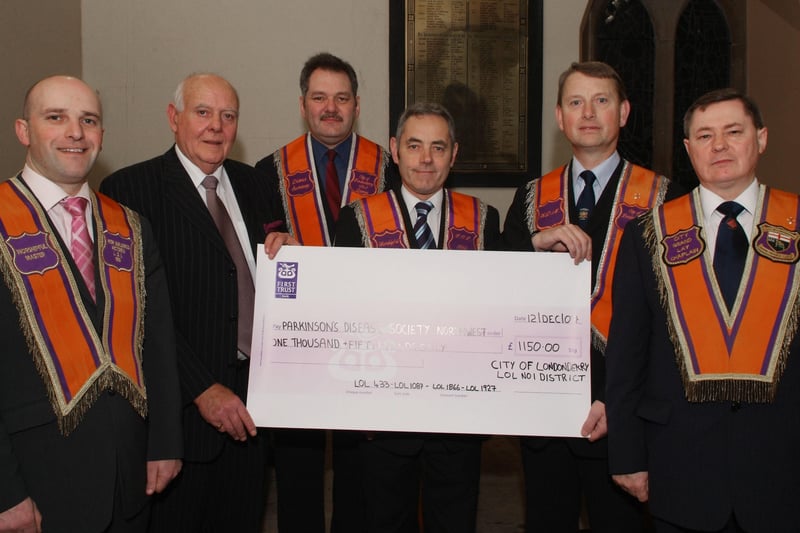 Alderman Maurice Devenney, second from right, Worshipful Master, City of Londonderry LOL District No.1, pictured handing over a cheque for £1,150.00, proceeds of a sponsored walk from Newbuildings to Culmore by the members of the four district lodges, to Jack Glenn, chairperson of the North West Branch of the Parkinson's Disease Society. Included are, from left, Kenneth Kincaid, LOL 1087, Billy Stewart, LOL 433, Noel Baird, LOL 1866, and William Jamison, LOL 1927. LS51-188KM