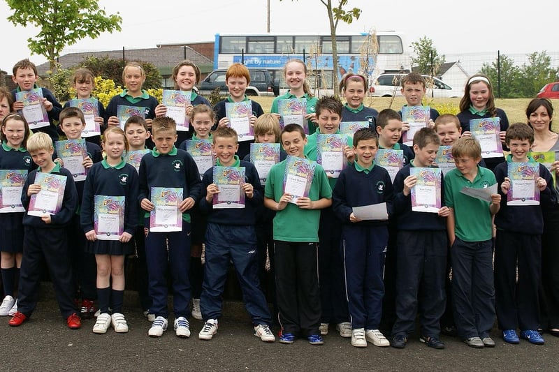 Constable Tony Quinn - PSNI Community Involvement, Waterside - Presenting certificates to Year 7 pupils from St. Colmcille's Primary School, Claudy on completion of a Citizenship and Safety Education Programme of work.

Also pictured are school principle Mrs Briege O'Neill and Year 7 teacher Miss Edel McLaughlin.