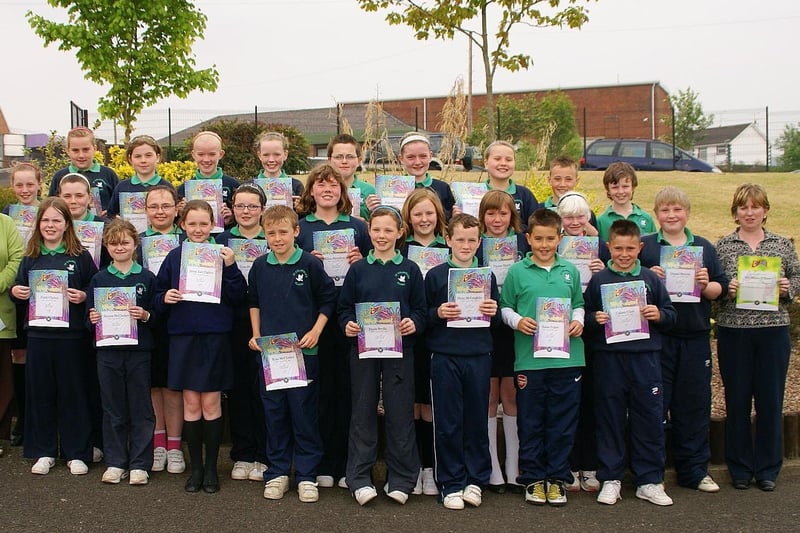 Constable Tony Quinn - PSNI Community Involvement, Waterside - Presenting certificates to Year 7 pupils from St. Colmcille's Primary School, Claudy on completion of a Citizenship and Safety Education Programme of work.

Also pictured are school principle Mrs Briege O'Neill and Year 7 teacher Mrs O'Kane.