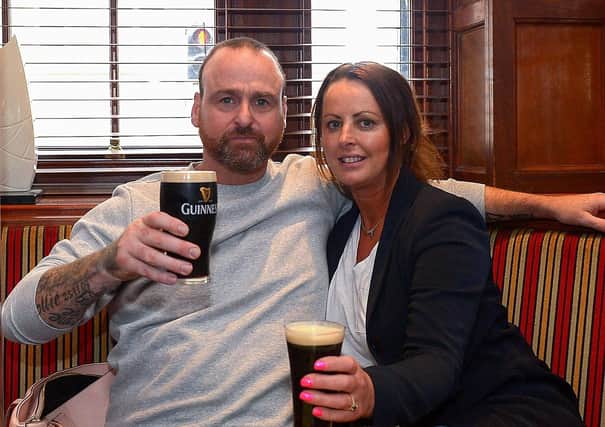 John Paul Doherty and Leona McKeever enjoy a lunch time Guinness in Badgers Bar and Restaurant yesterday afternoon as pubs reopened for indoor service. Photo: George Sweeney / Derry Journal.  DER2121GS – 001