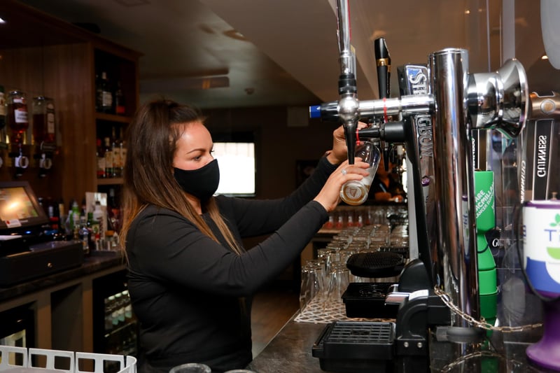 Restrictions on indoor hospitality have eased. Sinead from Dan's Bar on the Springfield Road serves up the first pint of the day.

Picture: Philip Magowan / PressEye