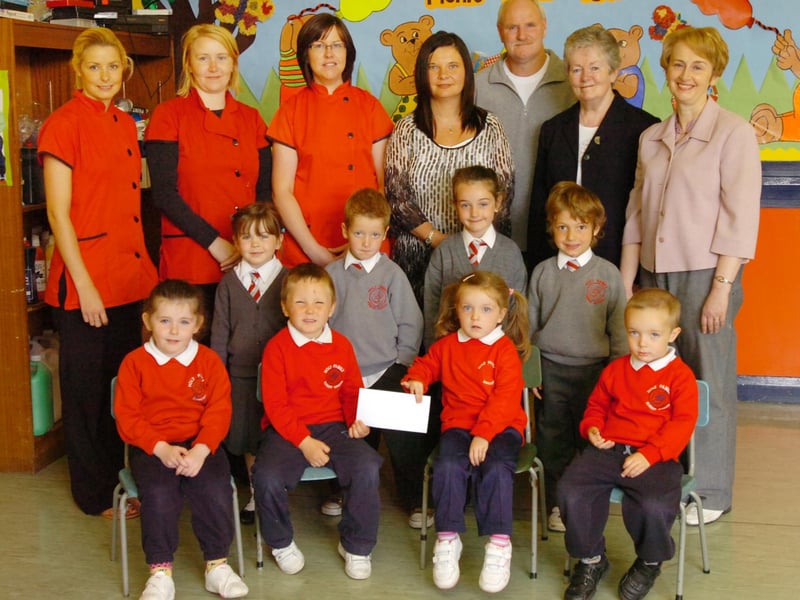 Children from Holy Family Primary School P1 class and Nursery who have taken part in a fun fitness event and organised a raffle present a cheque for £650 to Sister Ann, second right, and Gerry Deeney, fundraiser, which will go to help children attending the Sacred Heart Primary School in Bareilly, India. Included, front from left, Ellie Sharkey, Che-Eoin Temple, Amber Masterson and Daniel McDaid. Middle row, from left, Enya McDermott, Adam McLaughlin, Jane Houston and Regan McCaul. Back row, from left, Lisa Quinn, Michaela Robinson, Sonia Harkin, Linda Parke, teacher, and Catherine Donaghey, vice principal. (2706PG03)