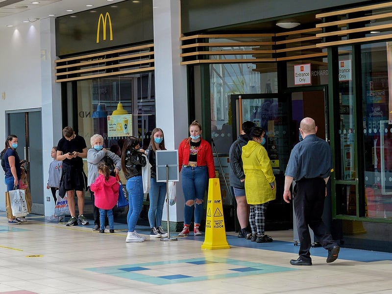 Customers queue for a fast food takeaway in Foyleside Shopping Centre. DER2119GS – 007
