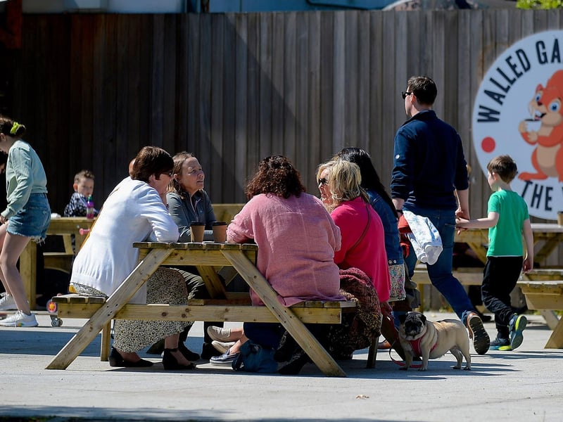 Customers enjoy a coffee in the sunshine, at St Columb’s House cafe, in St Columb’s Park, on Sunday afternoon last. DER2120GS – 012