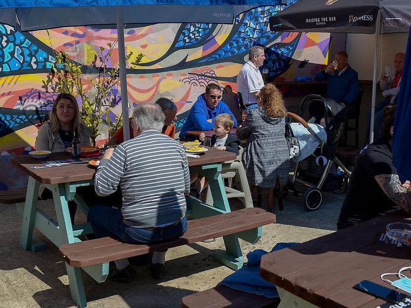 Customers enjoy lunch in the sunshine as pubs with outdoor service reopened on Friday last. Photo: George Sweeney / Derry Journal. DER2117GS - 047