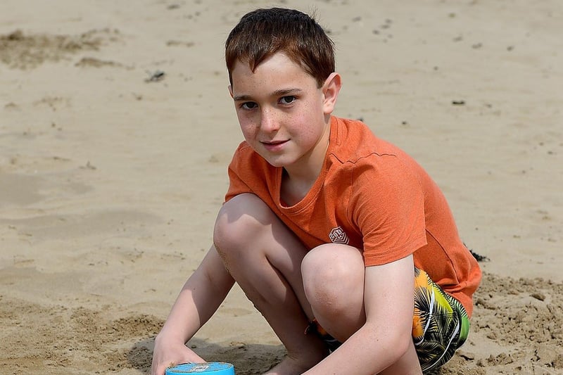 Sean Day, aged 9, from Derry builds sand castles in the sunshine at Lady’s Bay beach, Buncrana yesterday afternoon. Photo: George Sweeney / Derry Journal.  DER2122GS – 014