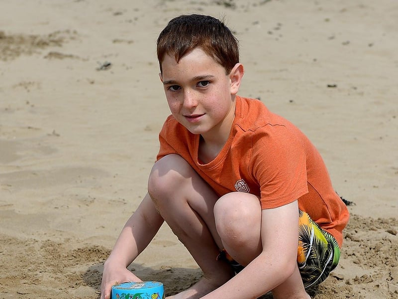 Sean Day, aged 9, from Derry builds sand castles in the sunshine at Lady’s Bay beach, Buncrana yesterday afternoon. Photo: George Sweeney / Derry Journal.  DER2122GS – 014