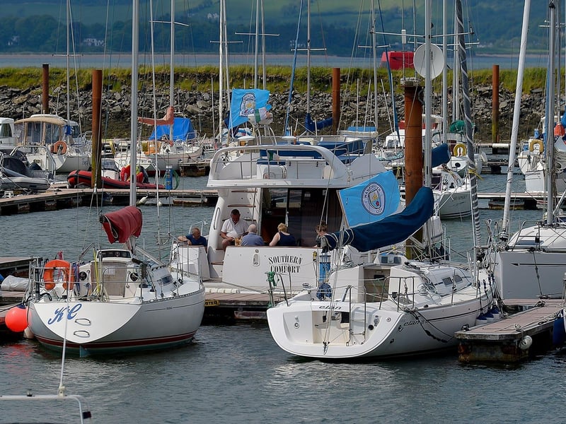 People enjoy the bank holiday sunshine on board a yacht moored at Fahan Marina yesterday afternoon. DER2122GS – 020