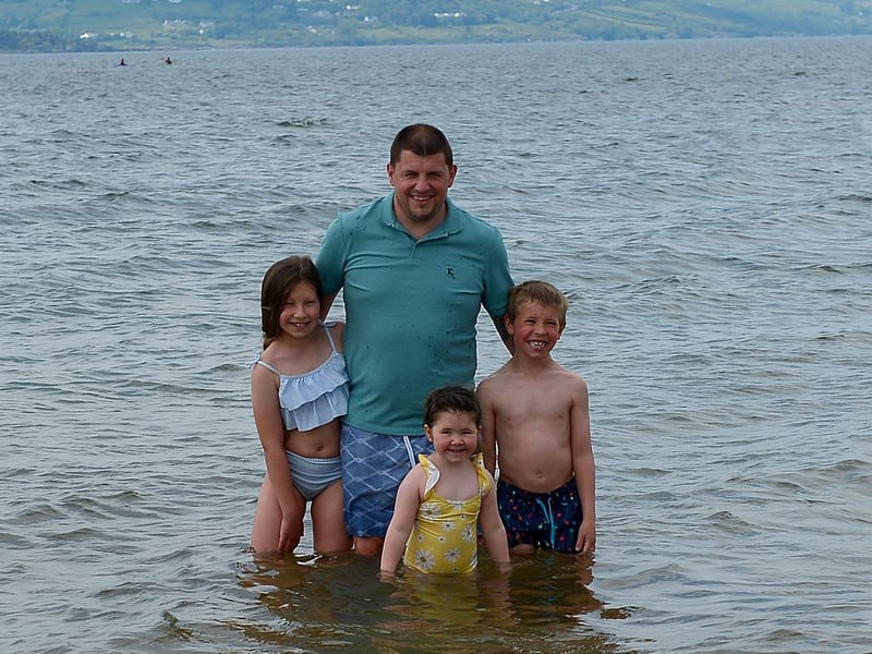 Hannah, Meabh and Lorcan Begley pictured with their dad Damien at Lady’s Bay beach, Buncrana yesterday afternoon.  DER2122GS – 017