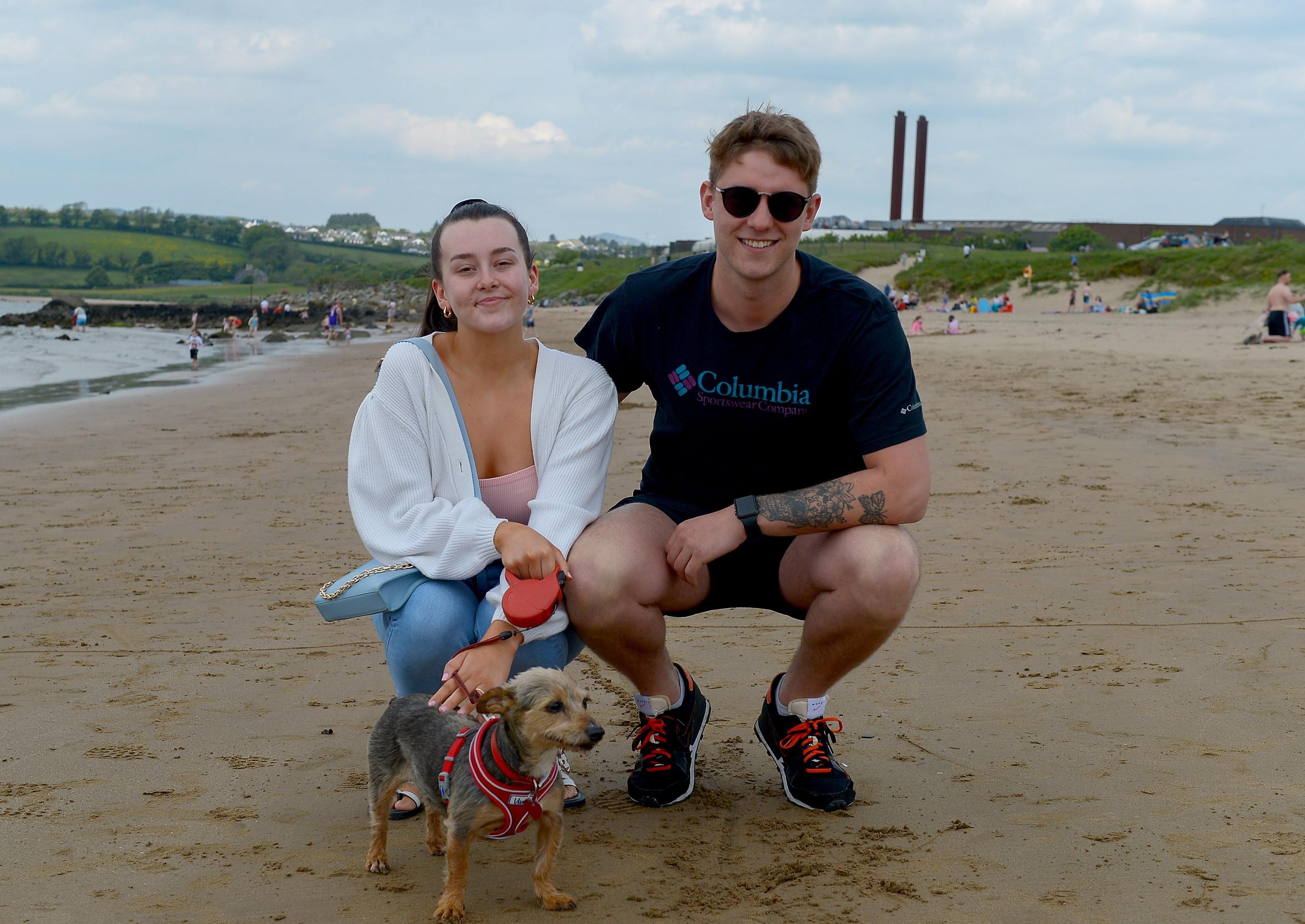 Eirn Hamilton, Caolan Kearney and Fudge the dog, from Derry, at Lady’s Bay beach, Buncrana yesterday afternoon. Photos: George Sweeney. DER2122GS – 015