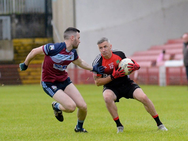 Sean Dolans Kevin Nixon gets possession ahead of Glack’s Ryan O’Kane during the Neal Carlin Cup final in Celtic Park on Friday evening last. (Photo: George Sweeney)