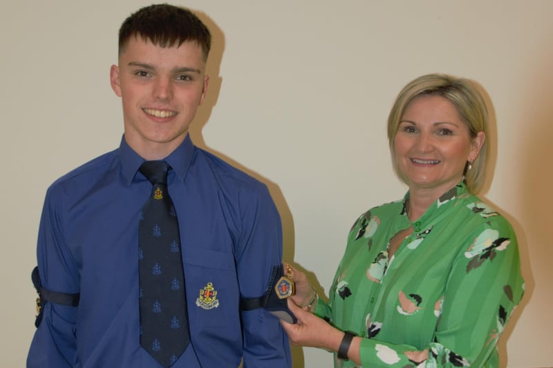 Mark Faulkner being presented with his Queen's badge by his mum Christina