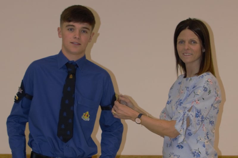 Sam Reid being presented with his Queen's badge by his mum Ann