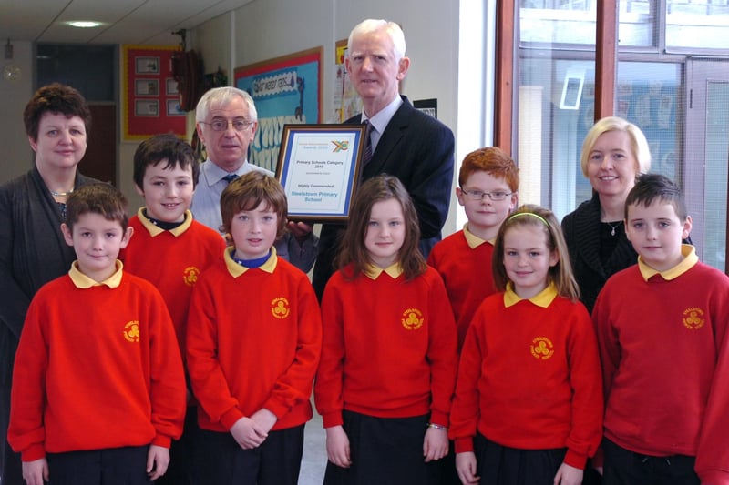 Staff and pupils from Steelstown Primary School receive the Schools Videoconference Award in which they were highly commended in the Primary Schools category. Included, front from left, are Cal McLaughlin, Ben McCarron, Luke Crampsey, Cara Doherty, Eoghan Mullan, Rebekah McGettigan and Tiernan Doherty. Back row, from left, are Deidre Gillespie, principal, Peter Heaney, class teacher, and Jack Gillen and Caroline Horan from C2K. (0312PG09)