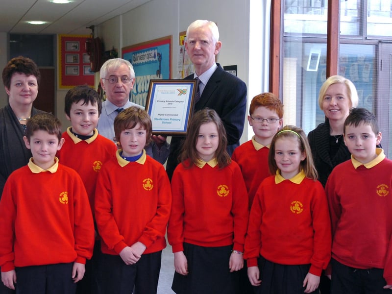 Staff and pupils from Steelstown Primary School receive the Schools Videoconference Award in which they were highly commended in the Primary Schools category. Included, front from left, are Cal McLaughlin, Ben McCarron, Luke Crampsey, Cara Doherty, Eoghan Mullan, Rebekah McGettigan and Tiernan Doherty. Back row, from left, are Deidre Gillespie, principal, Peter Heaney, class teacher, and Jack Gillen and Caroline Horan from C2K. (0312PG09)
