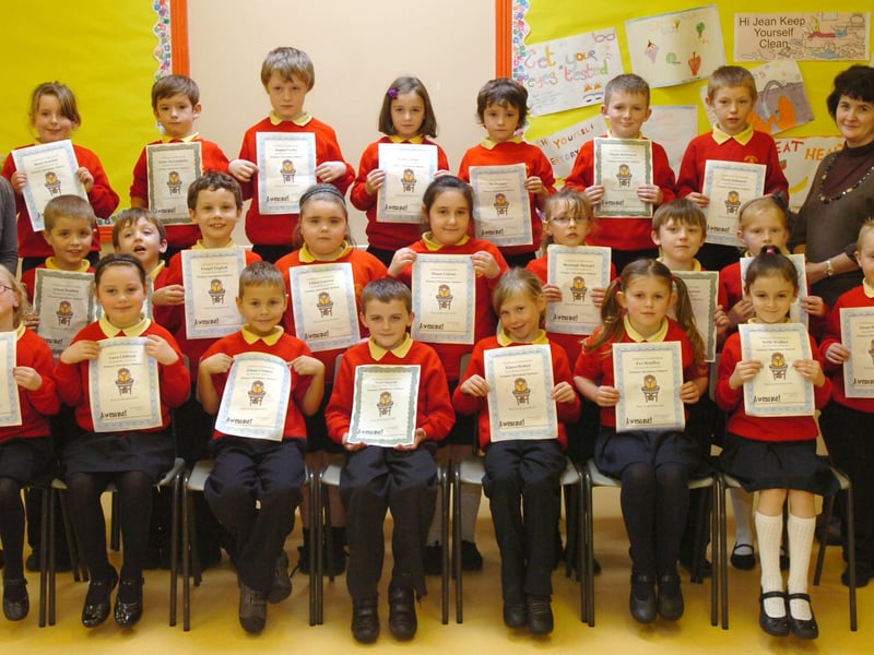 P4 pupils from Steelstown Primary School receive certificates for completing the Primary Attendance Matters programme. Included are Aine Doherty, left, education welfare officer, and Annette Devlin, teacher. (2910PG05)