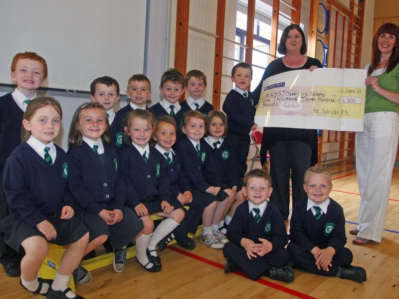 Pupils from St. Patrick's PS, Pennyburn P1 Year Group who took part in a recent Teddy Bears' Picnic to raise awareness and funds for children with epilepsy. The pupils raised an amazing £1,300 which will go towards supporting children with the condition. Presenting the cheque is Karen Crumley, charities co-ordinator, St. Patrick's PS to Kerrie Kerrigan, Epilepsy Nurse, representing WHSST (Paediatric Epilepsy. 2506JM28