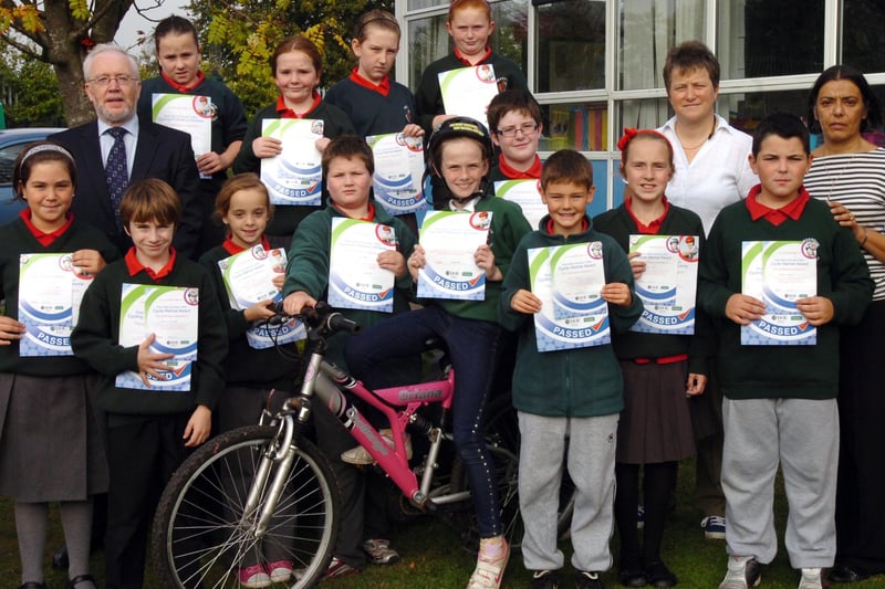 Children from Greenhaw Primary School receive certificates for completing a 3 week cycling proficiency test. Included are Ian Doherty, senior road safety education officer, teacher Linda Heaney and principal Vindi Torney. (1210PG28)
