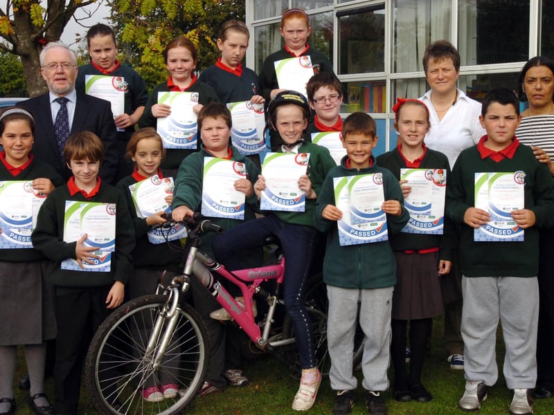Children from Greenhaw Primary School receive certificates for completing a 3 week cycling proficiency test. Included are Ian Doherty, senior road safety education officer, teacher Linda Heaney and principal Vindi Torney. (1210PG28)