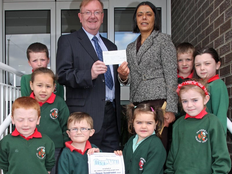 Ms. Vindi Torney, principal, Greenhaw PS handing over a cheque for £250, proceeds of a non-uniform day at the local school, to Billy McIlwaine, Foyle Down Syndrome Trust. Also in photo are pupils, Eoin McCafferty, Ethan Durey, Demi Lee McCallion, Aoife McCool, Caitlin McKinney, Chloe Doherty, Ethan Diamond and Anthony Sharkey. 2304JM10