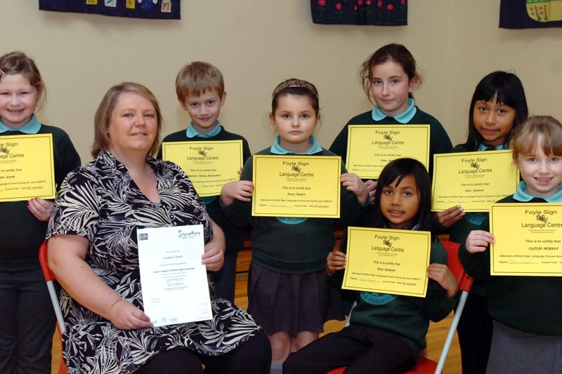 Pupils from Oakgrove Integrated Primary School receive certificates for attending a British Sign Language course at Foyle Language Centre. They are, from left, Erin Adams, teacher Josephine Heath who received a Level 1 certificate, Christian Temple Buchannan, Tegan Nesbitt, Emma Ball, Rafa Ardhami, Sara Ardhami and Caitlin Murray. (0511PG06)
