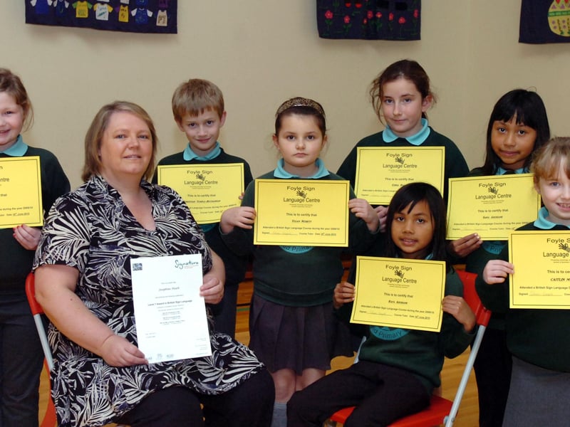 Pupils from Oakgrove Integrated Primary School receive certificates for attending a British Sign Language course at Foyle Language Centre. They are, from left, Erin Adams, teacher Josephine Heath who received a Level 1 certificate, Christian Temple Buchannan, Tegan Nesbitt, Emma Ball, Rafa Ardhami, Sara Ardhami and Caitlin Murray. (0511PG06)