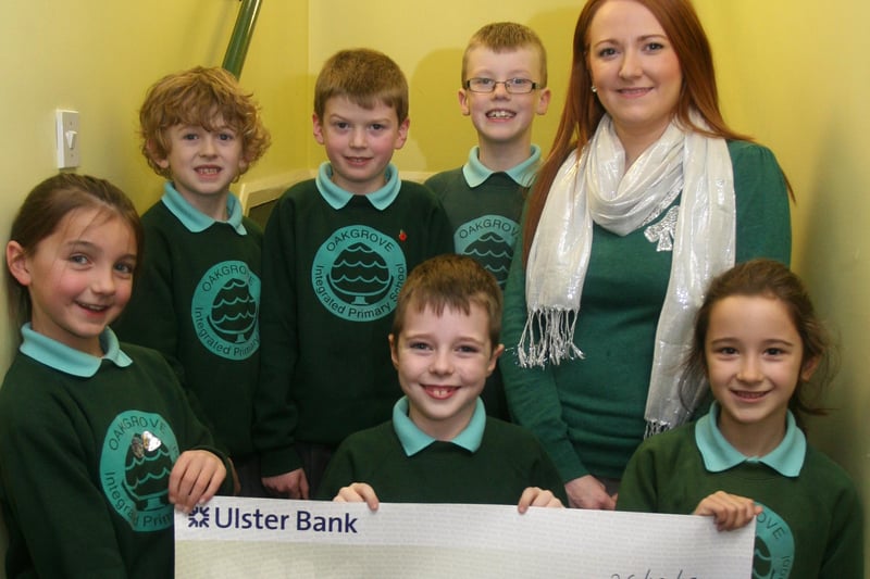 Oakgrove PS, Waterside P4/5 pupils pictured with a cheque for UNICEF UK for £1,062.72, proceeds of a 'Silver Coin Line' competition held in the school in aid of the Pakistan Emergency Flood Appeal. Front from left, Deirbhile Herron, Ryan Kyle and Emma Borland. Back from left, James Cochran, Conor Bratton, Evan Stanley and Miss Louise-Anne Quinn, teacher. 1211JM30