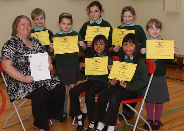 Pupils at Oakgrove Integrated Primary School, receiving certificates for attending a British Sign Language course at the Foyle Language Centre, pictured with Josephine Heath, who received a Level 1 certificate.  The pupils are (seated), sisters Rafa and Sara Ardhami, and standing (from left), Christian Temple Buchanan, Tegan Nesbitt, Emma Ball, Erin Adams and Caitlin Murray.  INLS4510-511MT.