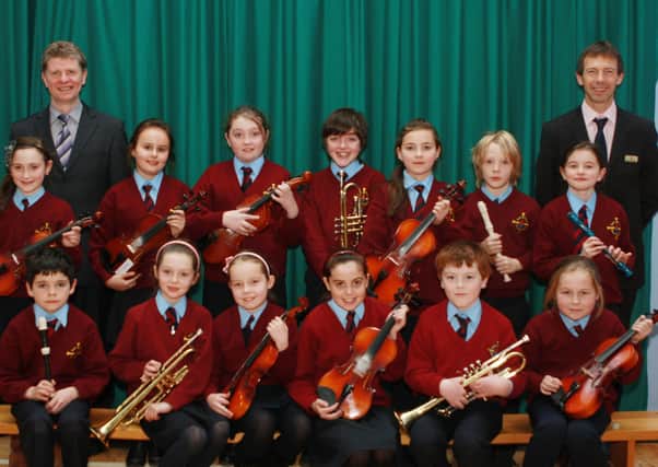 St. Eithnes PS pupils who have recently achieved music awards from Trinity College of Music, London.  The students are pictured here with school priocipal Mr Cosgrove and music teacher Mr Gormley.  (0312JB04)