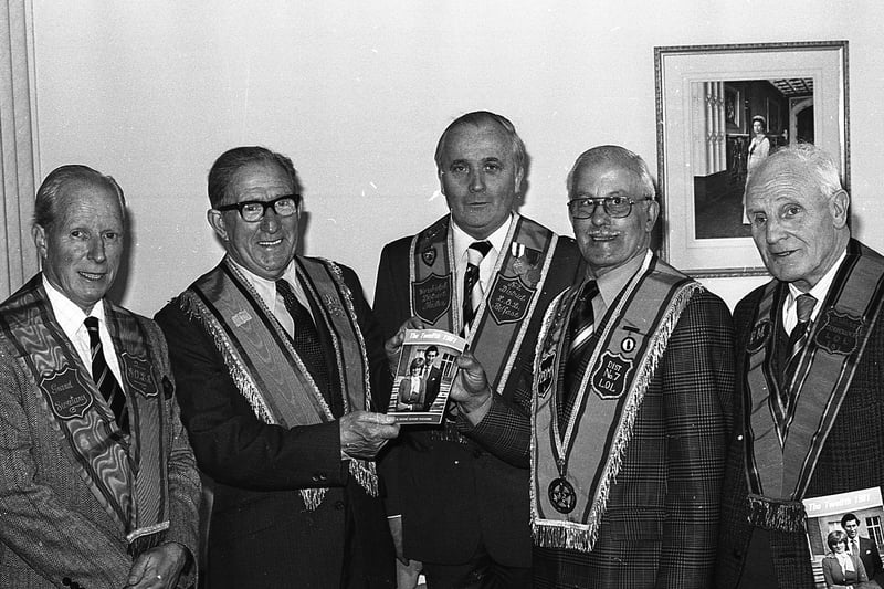 George Rice, second right, chairman of the County Grand Lodge of Belfast publication's committee, presenting the first copy of the 1981 Twelfth booklet to Tommy Farr, a long-standing associate member at a ceremony in the House of Orange on the Dublin Road in May 1981. Also included are Mr Walter Williams, left. Imperial Grand Secretary, Thomas Hugh, Deputy County Grand Secretary and Mr S Allworth, right, committee member. Picture: News Letter archives