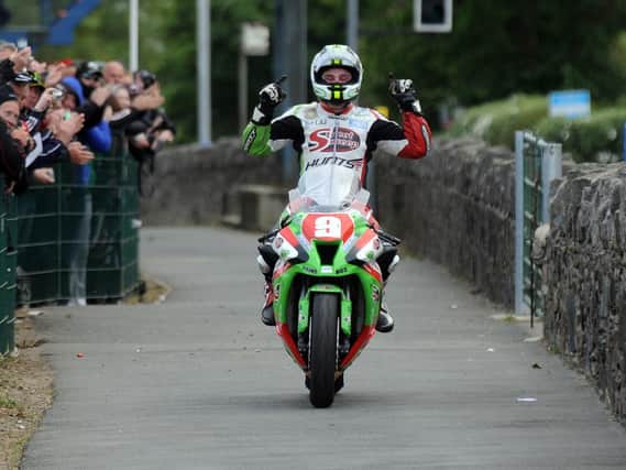 Michael Dunlop celebrates victory in the 2011 Superstock TT on the MD Racing/Street Sweep Kawasaki ZX-10.