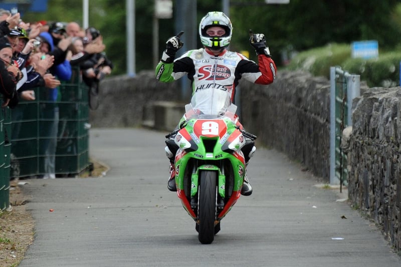 Michael Dunlop celebrates his first 'big bike' win at the Isle of Man TT in the Superstock race in 2011.