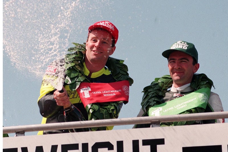 Ultra-Lightweight TT winner Ian Lougher on the rostrum with Robert Dunlop, who finished third. Out of shot is runner-up Denis McCullough.