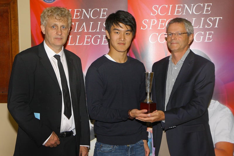 Pupil Yang Xu collecting the Du Pont award in A2 chemistry, from Mr. Claude Metzdorf, plant manager, at the Lumen Christi College annual senior prize giving.  Included is Dr. Michael Joyce, Head of Chemistry. Picture. Maurice Thompson.