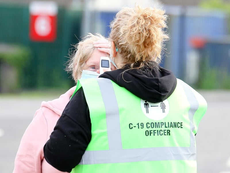 The Covid-19 compliance officers are hard at work as fans begin to enter the Showgrounds carpark.
