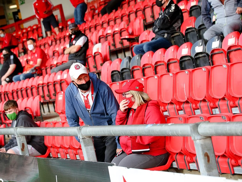 TAKE A SEAT . . . . These fans are getting used to their new vantage points in the Southend Park stand.