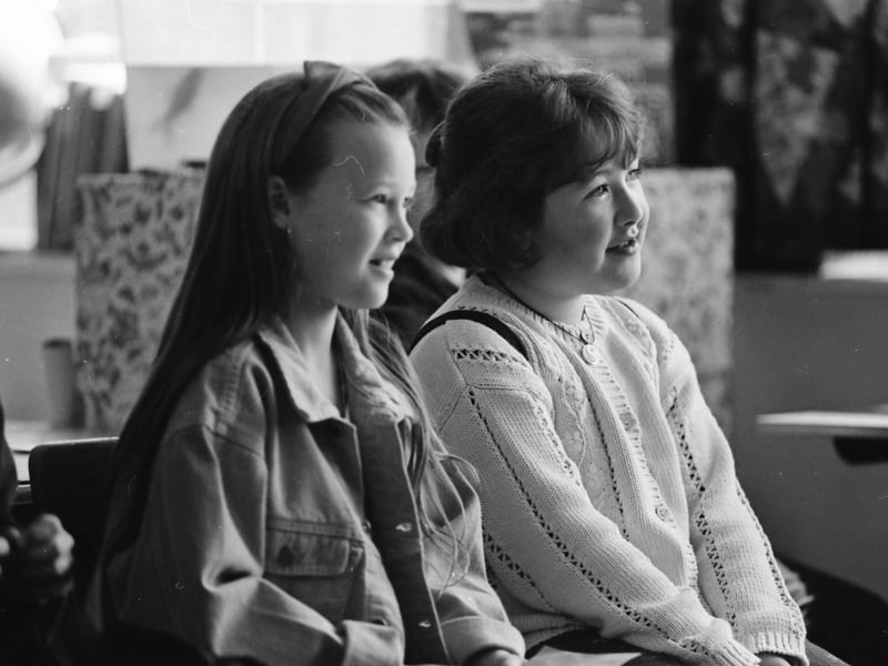 Terrie Shiels, Mountjoy Street, and Áine Ní Seoige, Brandywell, listen as the results of the U-9 Irish Language conversation competition are announced at the Co. Derry Fleadh at Holy Child Primary School.