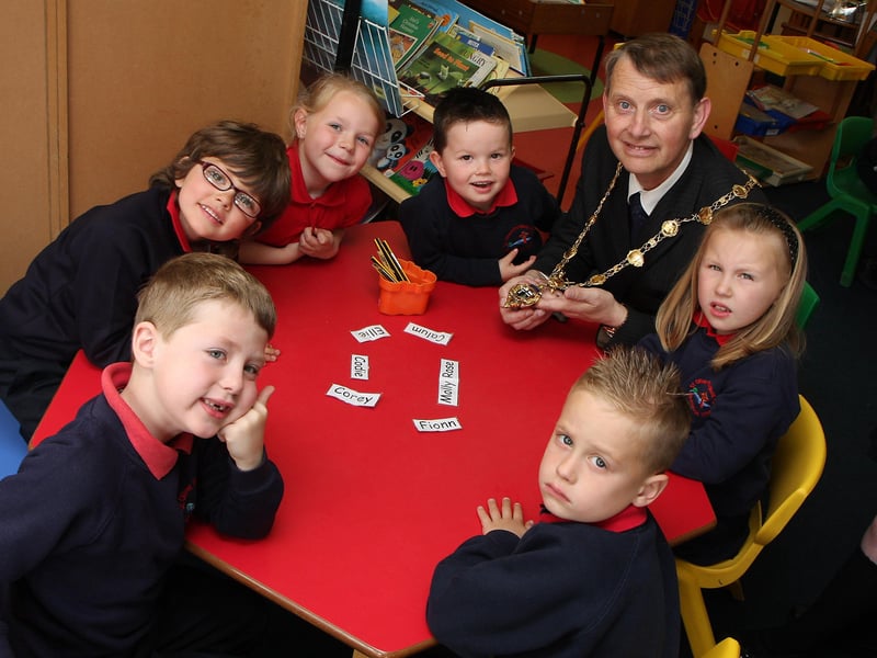 The Mayor of Derry Alderman Maurice Devenney, on his courtesy visit to St. Oliver Plunkett primary school, Strathfoyle, shows his chain of office to class P1 pupils.