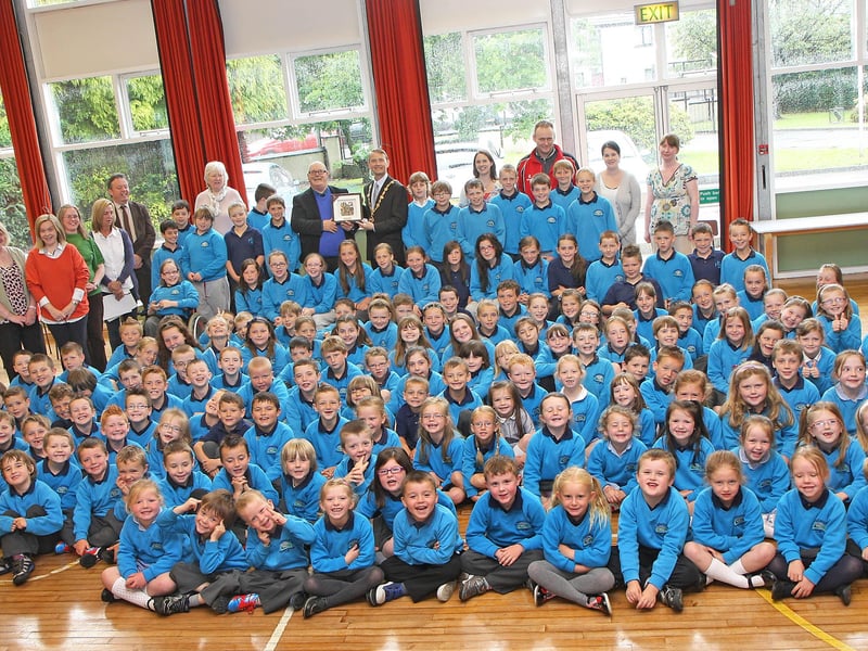The Mayor of Derry Alderman Maurice Devenney, presents a special Civic gift to Chris Scholes, principal of Newbuildings primary school, during his courtesy visit to the school, pictured with school pupils assembled for the occasion.