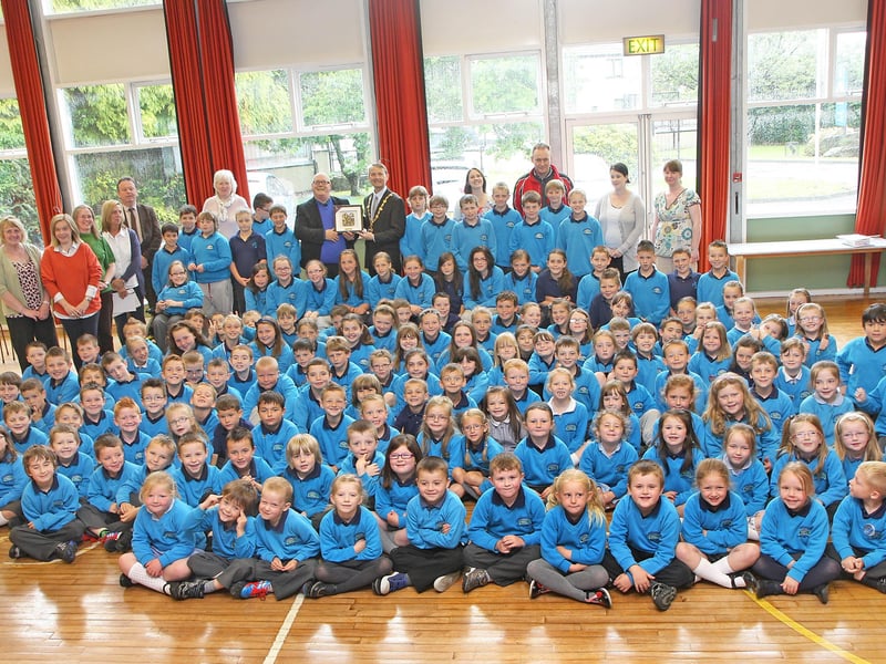The Mayor of Derry Alderman Maurice Devenney, presents a special Civic gift to Chris Scholes, principal of Newbuildings primary school, during his courtesy visit to the school, pictured with school pupils assembled for the occasion.