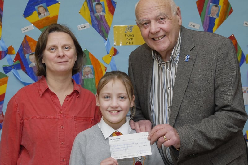 Fountain Primary School pupil Leona Orr pictured handing over a cheque for £170.00, raised during their Christmas Service in Carlisle Road Methodist Church, to Jack Glenn, Chairperson of the Foyle Branch of Parkinson's UK. Included is Cathy Arthur, Principal. INLS5212-111KM