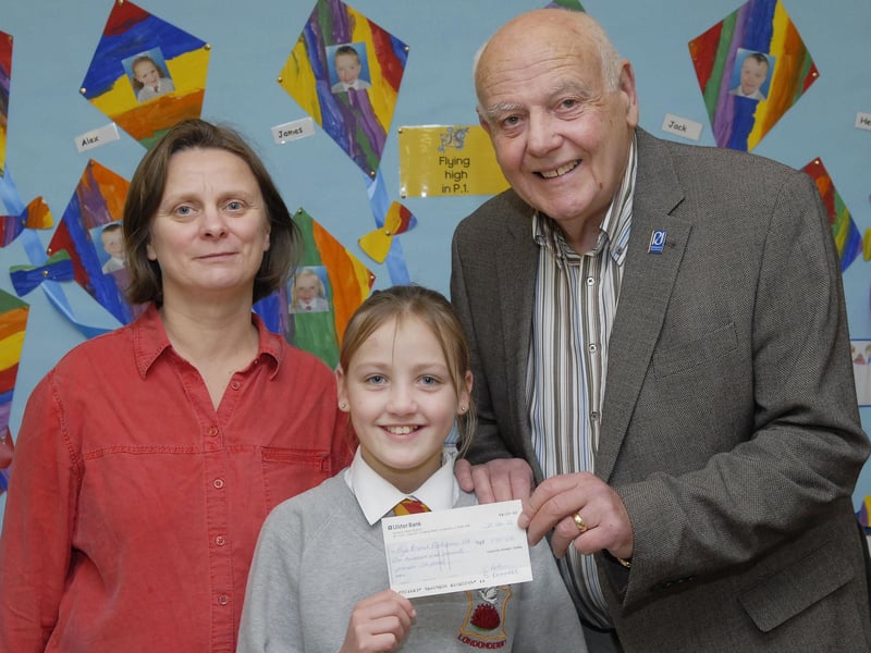 Fountain Primary School pupil Leona Orr pictured handing over a cheque for £170.00, raised during their Christmas Service in Carlisle Road Methodist Church, to Jack Glenn, Chairperson of the Foyle Branch of Parkinson's UK. Included is Cathy Arthur, Principal. INLS5212-111KM