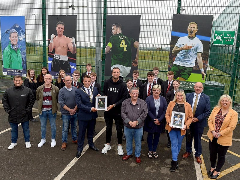 The Mayor of Derry and Strabane Graham Warke presents Shane Duffy with a photograph of Shane’s sporting hero mural, by local artist Joe Campbell, on display at the Leafair Well-Being Village. Included in the photograph are Eddie Breslin, NIHE, sponsor, Peter McDonald, Leafair Community Centre, Colrs Angela Dobbins and Sandra Duffy, Gerry McMonagle, vice-principal St Brigid’s College and Karen Mullan MLA.  Photos: George Sweeney / Derry Journal DER2125GS - 028