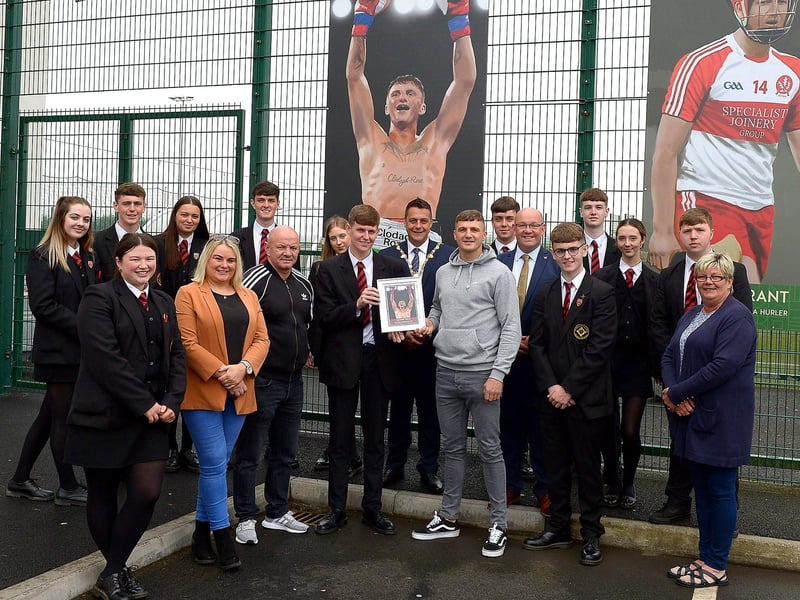 Boxer Conor Coyle receives a photograph of his sporting hero mural, by local artist Joe Campbell, on display at the Leafair Well-Being Village from pupils of St Brigid’s College. Included in the photograph are the Mayor of Derry and Strabane Graham Warke, Gerry McMonagle, vice-principal St Brigid’s College, Colr. Sandra Duffy and Colr. Angela Dobbins. Photos: George Sweeney / Derry Journal DER2125GS - 027