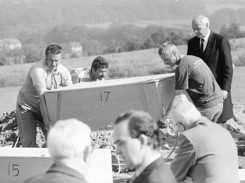 Grave diggers lower the remains of Great Hunger victims into the ground at Ballyoan Cemetery.