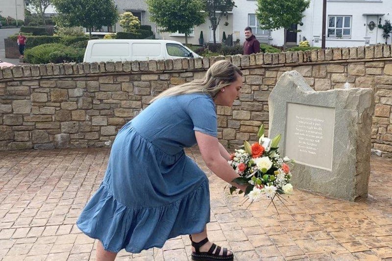 Nadine O’Hagan, niece of Vol. Jim O’Hagan, who died in a shooting in the Waterside on August 19, 1971, lays a wreath.