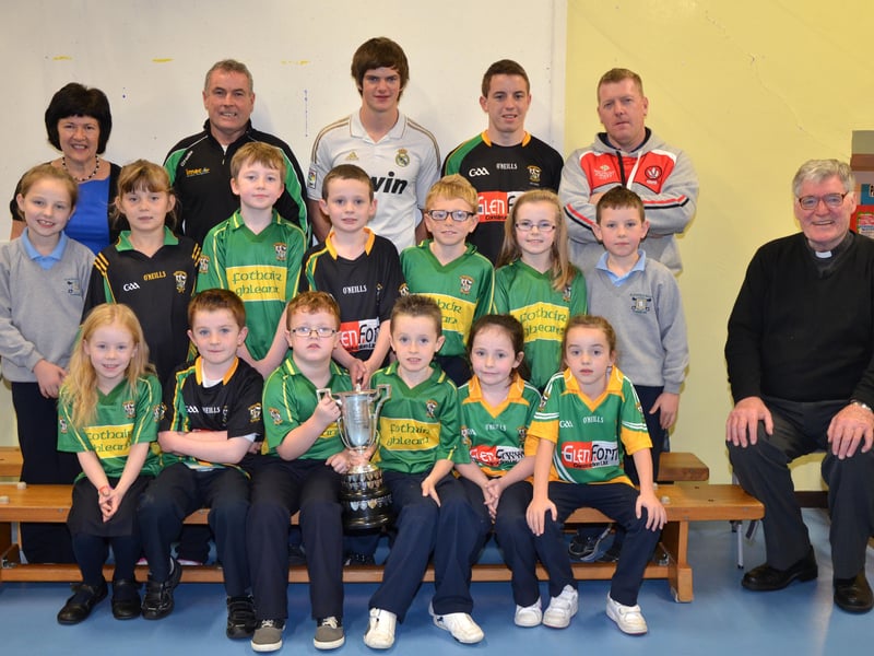 O'Brien's Foreglen club chairman Noel McFeely and senior players Eoighan Duffy and Eunan McFeely, with backroom management member Damien O'Connor pictured with the Intermediate Championship Trophy proudly displayed by the P4/P5 pupils at St. Peter's and St. Paul's Primary School, Foreglen on Friday morning. Also pictured is their class teacher, Mrs. Fiona McCann (Principal) and Rev. Fr. Art O'Reilly. DER4313JM002