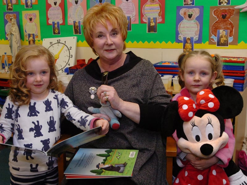 Anita Robinson reads bedtime stories to Annie, left, and Erin during the Big Bedtime Read event held at St Brigid's Primary School. (DER4713PG032)