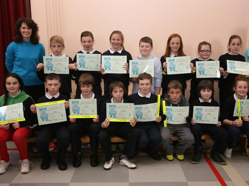 CYCLING AWARD. . . .Pupils from Bunscoil Cholmcille, Steelstown pictured on Thursday morning after receiving their National Standard Cycle Training Levels 1 and 2 awards at the school. On left is Caroline Nhic Colla, and on right, Michelle Murphy, Sustrans. 0905JM08